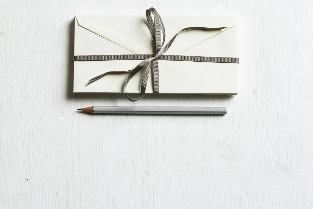 Corporate Voucher Scheme - Pencil and envelope on a desk