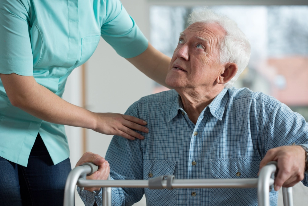 Elderly man being assisted - Eye Tests At Home