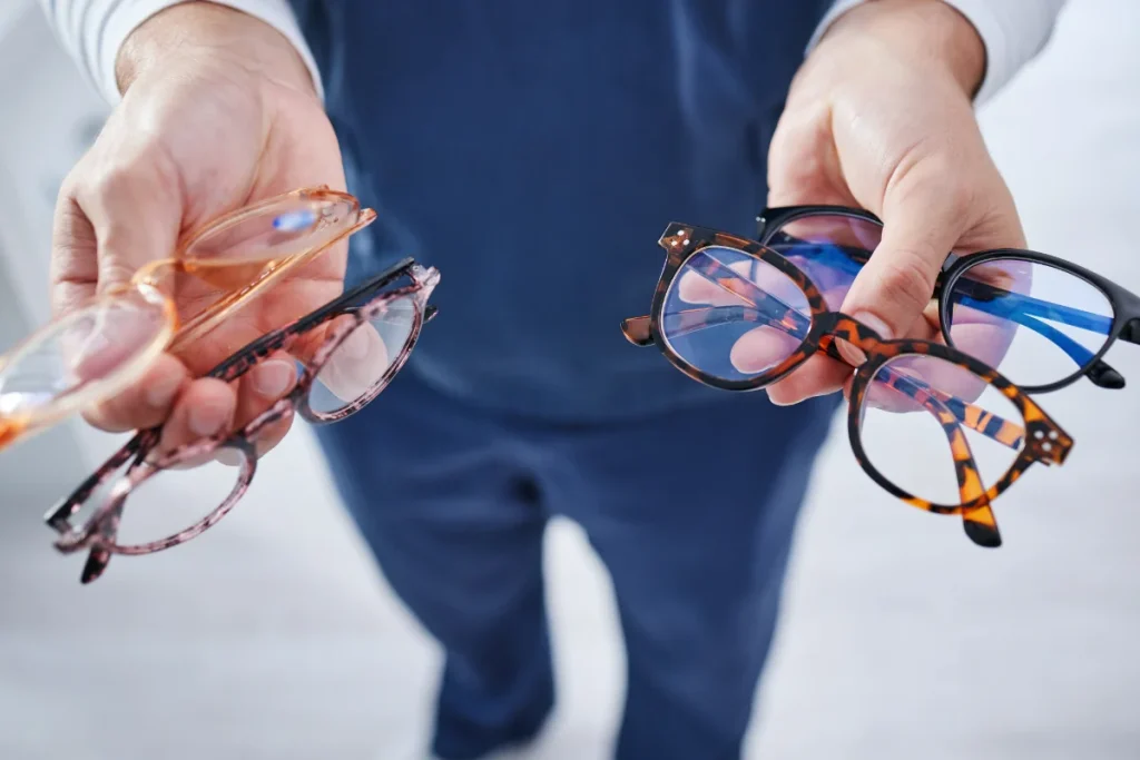 Choosing your frames - Man holding 4 pairs of glasses
